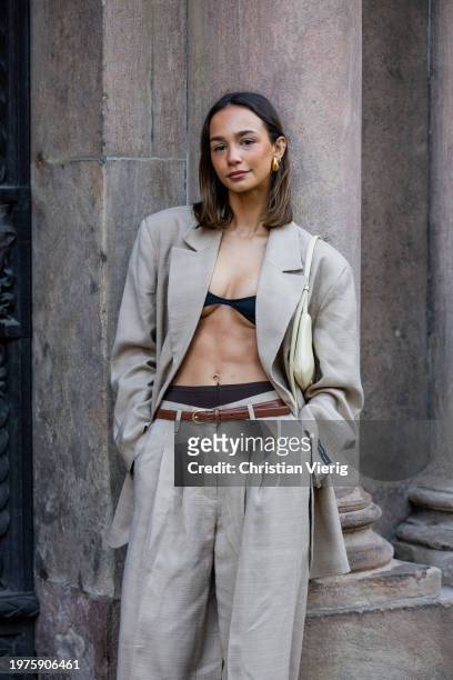 Blanca Arimany wears grey oversized blazer, pants, black cropped top outside Herskind during the Copenhagen Fashion Week AW24 on January 31, 2024 in...