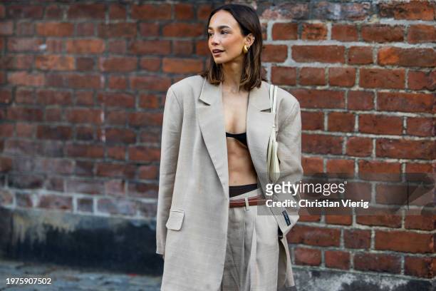 Blanca Arimany wears grey oversized blazer, pants, black cropped top outside Herskind during the Copenhagen Fashion Week AW24 on January 31, 2024 in...