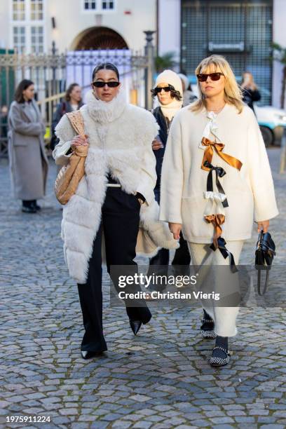 Benthe Liem wears creme white faux fur sleeveless jacket, beige Bottega Veneta bag & Elise Bak wears white jacket, black bag, skirt outside Herskind...