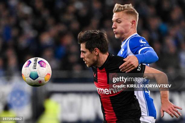 Bayer Leverkusen's German midfielder Jonas Hofmann and Darmstadt's German midfielder Andreas Mueller vie for the ball during the German first...