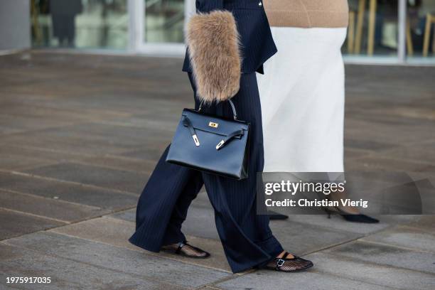 Noorie Ana wears striped coat with beige fur sleeves, black Hermes bag, pants outside OpéraSport during the Copenhagen Fashion Week AW24 on January...