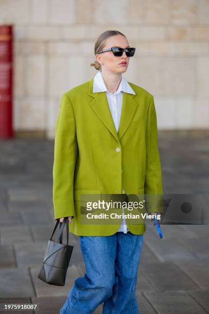 Guest wears mint green blazer, denim jeans, white button shirt, grey bag outside OpéraSport during the Copenhagen Fashion Week AW24 on January 31,...