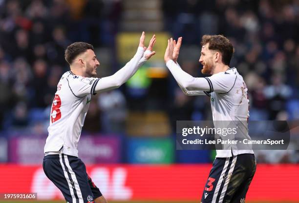 Bolton Wanderers' Aaron Collins gets a high five from Jack Iredale after he set up the equalising goal during the Sky Bet League One match between...