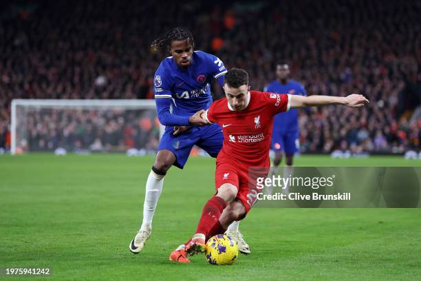 Diogo Jota of Liverpool is challenged by Carney Chukwuemeka of Chelsea during the Premier League match between Liverpool FC and Chelsea FC at Anfield...