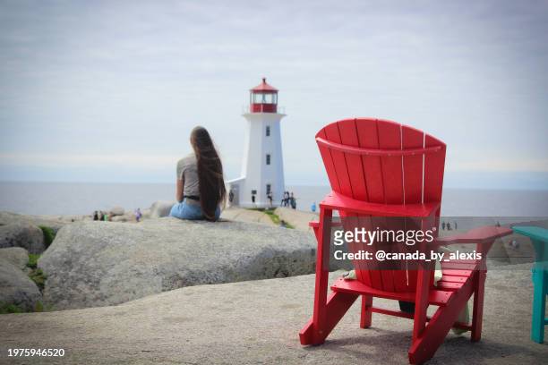 red adirondack chair in peggy's cove - adirondack chair closeup stock pictures, royalty-free photos & images