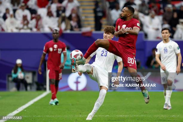 Qatar's midfielder Ahmed Fathy shoots the ball past Uzbekistan's defender Husniddin Aliqulov during the Qatar 2023 AFC Asian Cup quarter-final...