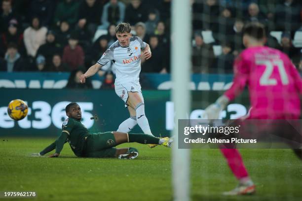 Przemyslaw Placheta of Swansea City crosses the ball past Bali Mumba of Plymouth Argyle during the Sky Bet Championship match between Swansea City...