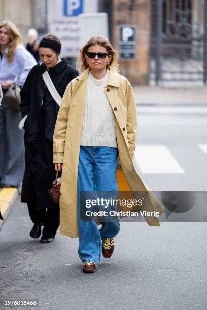 Guest wears beige coat outside The Garment during the Copenhagen Fashion Week AW24 on January 31, 2024 in Copenhagen, Denmark.