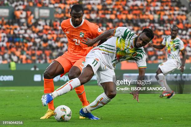 Ivory Coast's defender Evan Ndicka fights for the ball with Mali's midfielder Lassana Coulibaly during the Africa Cup of Nations 2024 quarter-final...