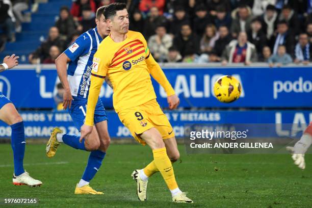 Barcelona's Polish forward Robert Lewandowski scores the opening goal during the Spanish league football match between Deportivo Alaves and FC...