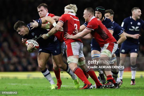 Scotland's centre Huw Jones is tackled by Wales' number 8 Aaron Wainwright during the Six Nations international rugby union match between Wales and...
