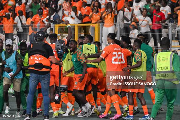 Ivory Coast's players celebrate scoring their team's first goal during the Africa Cup of Nations 2024 quarter-final football match between Mali and...