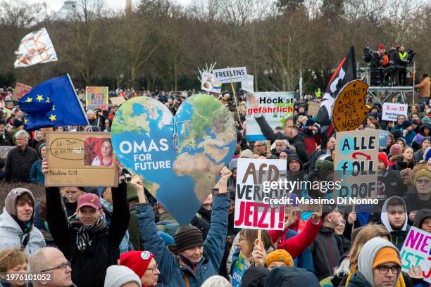 People show plakards against the far-right AFD party and razzism. People gather to form a human chain around the Reichstag, seat of the Germany's...