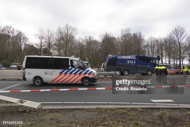 Police officers take security measures while hundreds of climate activists block the final section of the A12 main road leading to Parliament,...