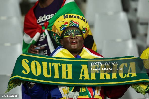 South Africa's supporter holds a scarf ahead of the Africa Cup of Nations 2024 quarter-final football match between Cape Verde and South Africa at...