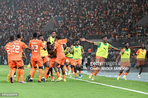 Ivory Coast's forward Oumar Diakite takes his jersey off as he celebrates with teammates after scoring his team's second goal during the Africa Cup...