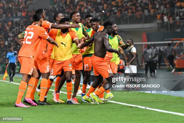 Ivory Coast's forward Oumar Diakite takes his jersey off as he celebrates with teammates after scoring his team's second goal during the Africa Cup...