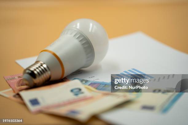 An electricity prices chart with a led lamp and banknotes.