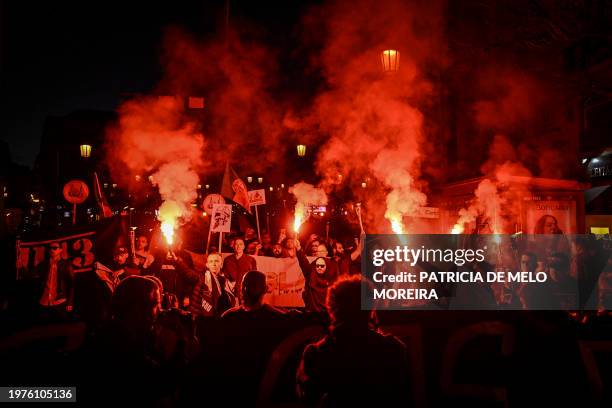 Members of the nationalist far-right movement "1143" light flares and chant slogans as they gather during a demonstration against immigration in...