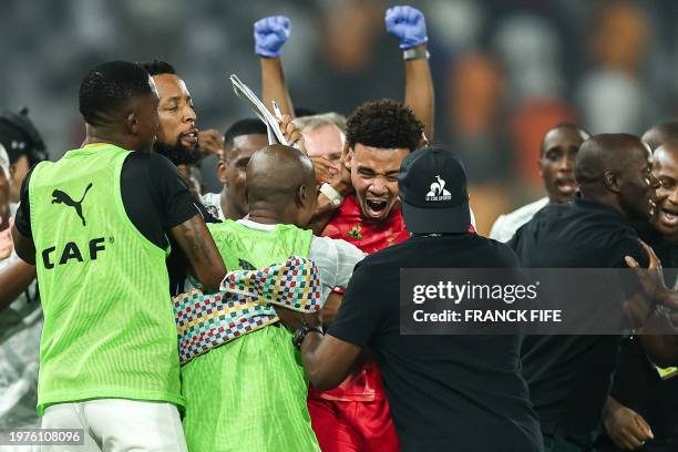 South Africa's goalkeeper Ronwen Williams celebrates with teammates after winning at the end of the Africa Cup of Nations 2024 quarter-final football...