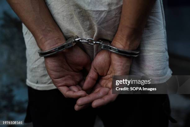 Man sits handcuffed after being arrested in San Salvador. On Sunday, El Salvador will head to the polls as Salvadoran President Nayib Bukele attempts...