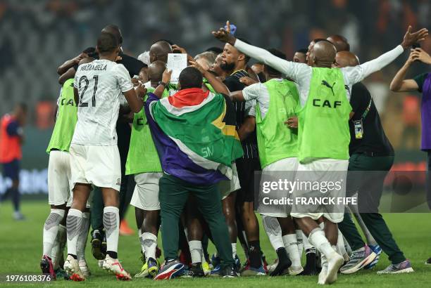 South Africa's players celebrate after winning at the end of the Africa Cup of Nations 2024 quarter-final football match between Cape Verde and South...