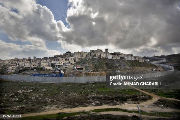 General view shows the Palestinian Shuafat refugee camp behind Israel's controversial separation barrier in east Jerusalem on January 19, 2012. AFP...