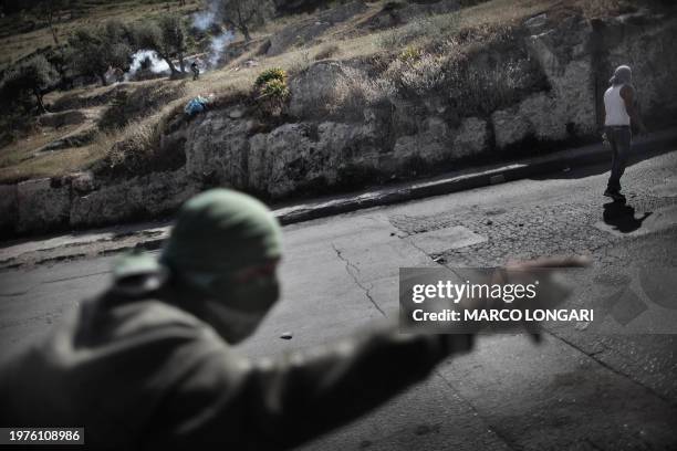 Masked Palestinian youths demonstrate in the flashpoint Jerusalem neighborhood of Silwan April 29, 2011 during clashes with Israeli police forces....