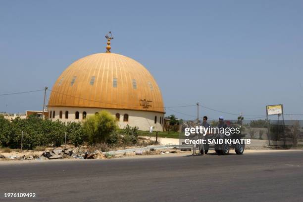 Palestinian man rides his past a mosque built on what formerly was the Jewish settlement of Neve Dekalim, close to Khan Yunis, in the southern Gaza...