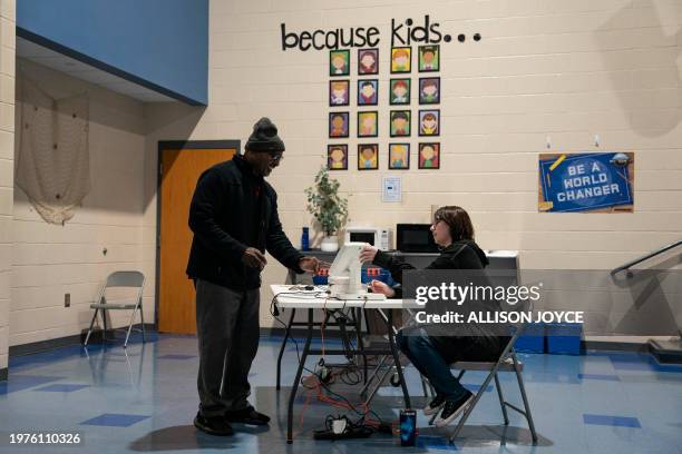Person checks in to vote in the Democratic Presidential Primary at a polling station on February 3, 2024 in West Columbia, South Carolina. President...