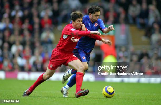 December 10: Xabi Alonso of Liverpool and Fabio Rochemback of Middlesbrough challenge during the Premier League match between Liverpool and...