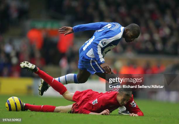 December 3: Peter Crouch of Liverpool and Damien Francis of Wigan Athletic challenge during the Premier League match between Liverpool and Wigan...