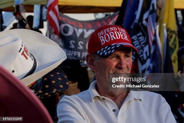 Ronald Solomon sits with Donald Trump merchandise he sells at the "Take Our Border Back Convoy" rally on February 3, 2024 in Quemado, Texas. Several...