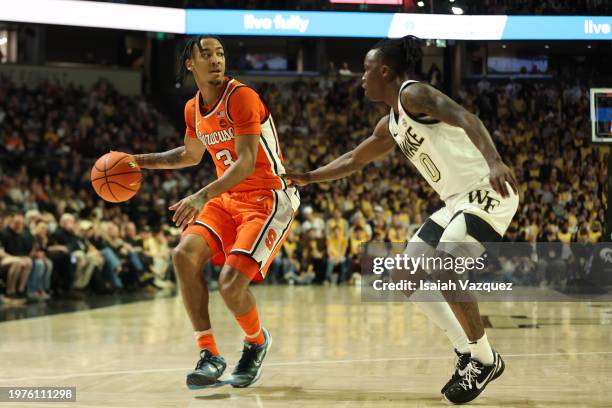 Judah Mintz of the Syracuse Orange moves the ball against Kevin Miller of the Wake Forest Demon Deacons at Lawrence Joel Veterans Memorial Coliseum...