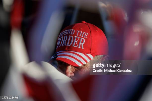 Ronald Solomon sits with Donald Trump merchandise he sells at the "Take Our Border Back Convoy" rally on February 3, 2024 in Quemado, Texas. Several...