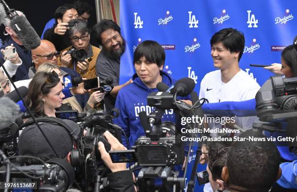 Los Angeles, CA Shohei Ohtani, right, of the Los Angeles Dodgers speaks to the media with the help of his interpreter Ippei Mizuhara during...