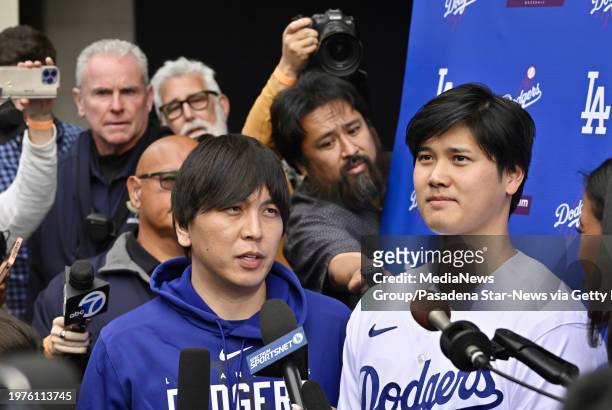Los Angeles, CA Shohei Ohtani, right, of the Los Angeles Dodgers speaks to the media with the help of his interpreter Ippei Mizuhara during...