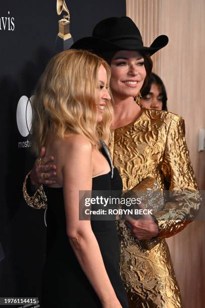 Australian singer-songwriter Kylie Minogue ans US singer Shania Twain arrive for the Recording Academy and Clive Davis' Salute To Industry Icons...