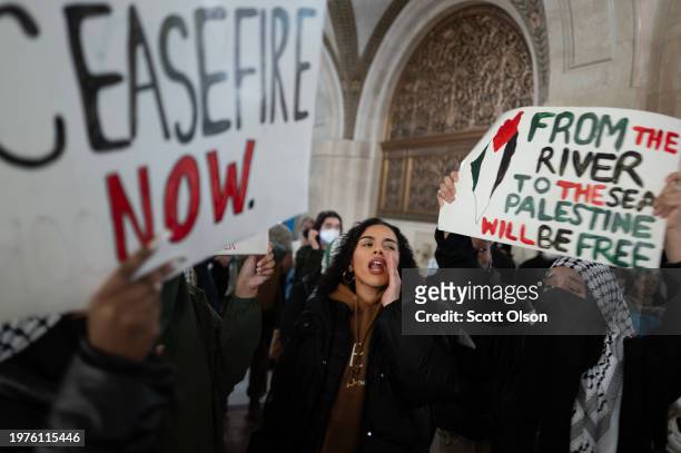 Pro-Palestine demonstrators rally in the lobby of City Hall while the City Council debates a symbolic resolution calling for a cease-fire in the war...