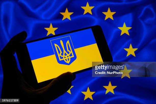 Smartphone is displaying the Ukraine flag with the European Union flag visible in the background in this photo illustration taken in Brussels,...