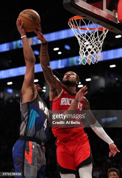 Cam Whitmore of the Houston Rockets blocks the shot of Dennis Smith Jr. #4 of the Brooklyn Nets during their game at Barclays Center on January 27,...