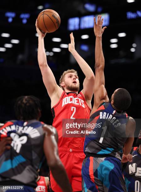 Jock Landale of the Houston Rockets shoots against Mikal Bridges of the Brooklyn Nets during their game at Barclays Center on January 27, 2024 in New...