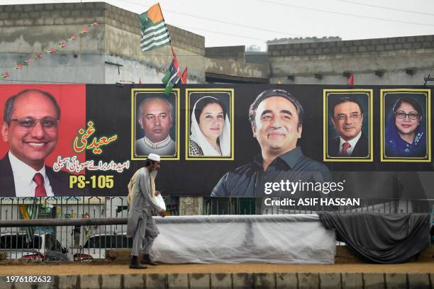 Man walks past an election banner displaying Bilawal Bhutto Zardari , chairman of Pakistan Peoples Party , along a street in Karachi on February 4...