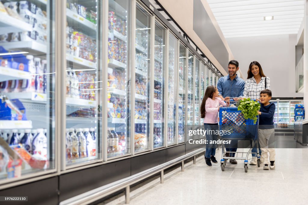 Happy family buying groceries at the supermarket