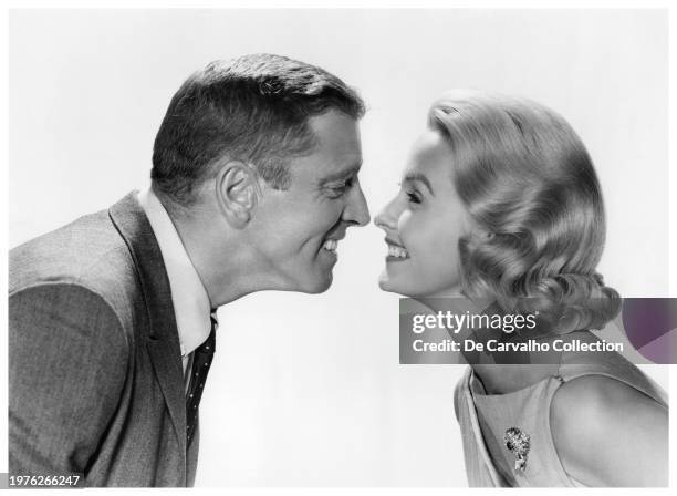 Publicity portrait of actors Burt Lancaster and Dina Merrill smiling at each other in the film 'The Young Savages' United States.