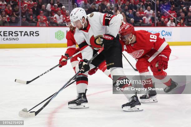 Drake Batherson of the Ottawa Senators tries to get around the stick of Andrew Copp of the Detroit Red Wings during the first period at Little...