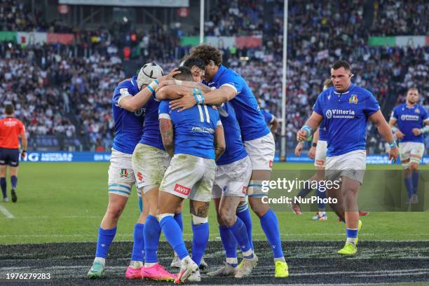 Players of Italy are celebrating after Monty Ioane scores a try during the first match of the Guinness Six Nations tournament between Italy and...