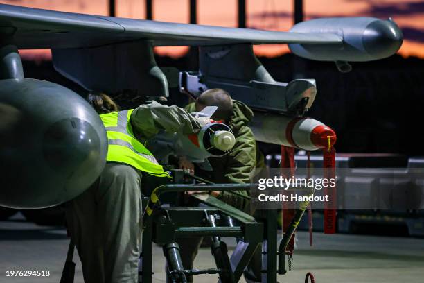 In this handout image provided by the UK Ministry of Defence, Royal Air Force Weapon Technicians prepare a RAF Typhoon FRG4s aircraft prior further...