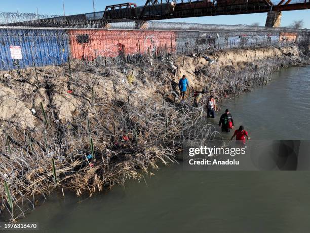An aerial view shows an immigrant group trying to cross the Texan border despite heightened security measures in Eagle Pass, Texas on February 03,...