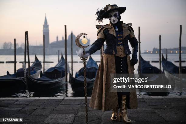 Masked reveller in period costume poses during the traditional Venice Carnival, on February 4, 2024.